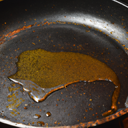A cast iron skillet being seasoned with vegetable oil.
